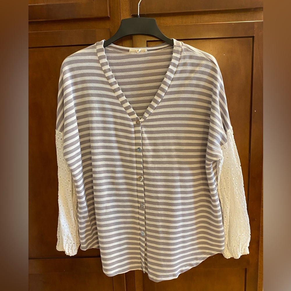 Gray and white v-neck button down long sleeve top.